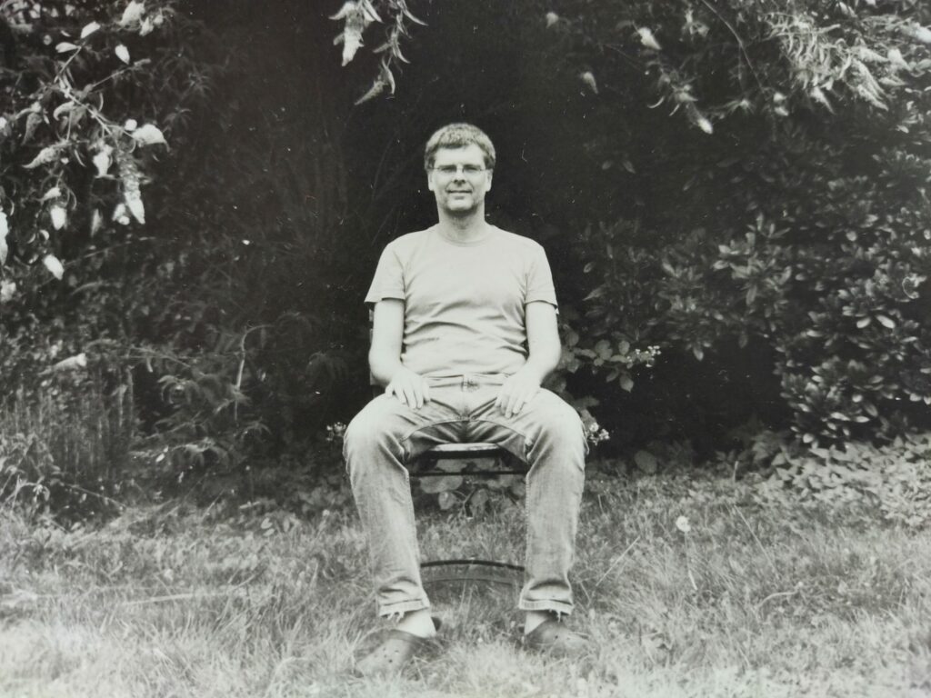 Sebastian sitting on a chair in the garden. Developed black-and-white picture